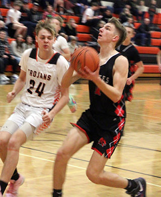 Briggs Rambo is about to score a lay-up for 2 of his 22 points at Troy. Behind him is Phil Schwartz.