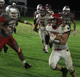 Chris Schumacher picks up yardage running the ball at C.V. Also shown is Dylan Uhlenkott.