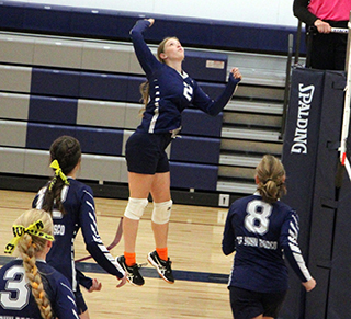 Julia Wassmuth goes for a spike against Genesee on Senior Night. Also shown are Rachel Sonnen, Savannah Perrin and Noelle Chmelik.