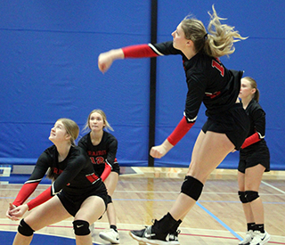 Kylie Schumacher spikes the ball against Lapwai at District. Also shown are Hailey Hanson, Avery Riener and Mia Anderson.