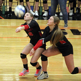 Sierra Oliver and Lexi Schumacher almost collide going after a serve against Liberty Charter.