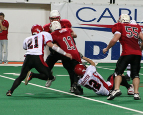 Derek Schaeffer hangs on to the Oakley QB until he can get help with the sack from Andrew Gabica.