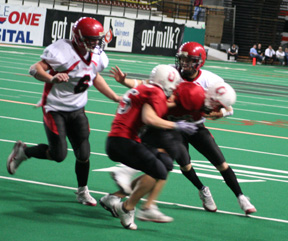 Devin Schmidt cuts back inside of two Oakley defenders as Branden Waller comes in to help block. Schmidt scored on the play and then added the 2-pointer to put Prairie ahead 14-0.