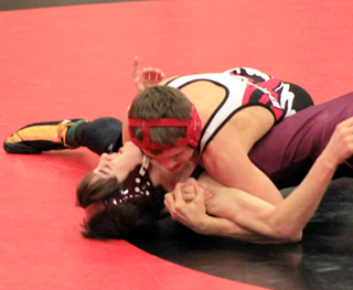 Dally Ratcliff is about to pin Logan Webber of Kittitas in the championship match at 120 lbs.