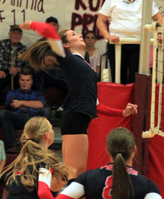 Krystin Uhlenkott goes for a kill. She and Hailey Danly, below right, were definitely synched up as Uhlenkott scored a kill on nearly every spike. Also shown are Leah Higgins and Hailey Danly.