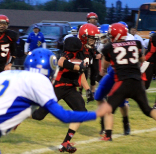 Calvin Hinkelman, 23, blocks a defender to clear the way for Luke Wemhoff, with ball, to break through for what turned out to be a 48 yard touchdown run.