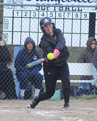 Mackenzie Key is about to connect in the second game for a grand slam homer.