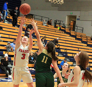 Kristin Wemhoff shoots a lay-up against Pendleton as Tara Schlader gets ready for a possible rebound.