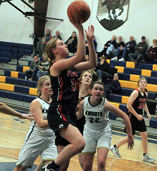 Alli Geis goes for a lay-up at Logos. Also shown are Tara Schlader and Hailey Hanson.