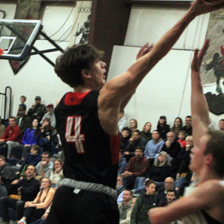 Riley Shears goes for a lay-up at Logos.