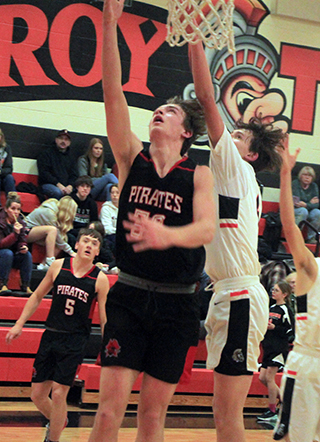 Lee Forsmann scores a lay-up at Troy. Also shown is Trenton Lorentz.