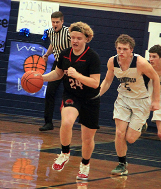 Noah Behler heads down the floor against Grangeville and is being chased by his cousin Carter Mundt.