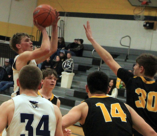 Cody Wassmuth goes for 2 of his 31 points against Highland at District. Also shown is Levi Wassmuth.