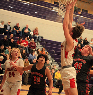 Lee Forsmann scores against C.V. at District. Also shown is Noah Behler.