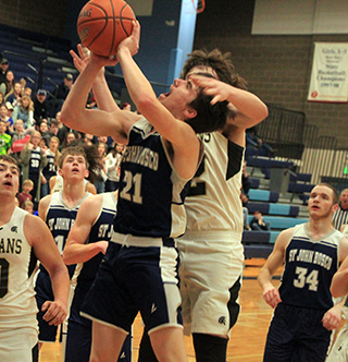 Clay Weckman gets fouled as he goes for a lay-up against Timberline in the 2nd place game at District. Also shown are Cody Wassmuth and Levi Wassmuth.