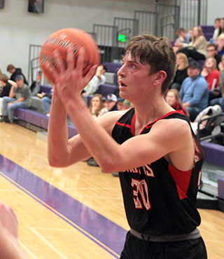 Lee Forsmann lines up a 3-point shot against Troy at District.