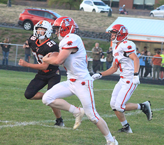 Dylan Uhlenkott races past a Troy defender for the second of his 3 touchdowns. Also shown is Levi Gehring.