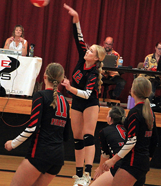 Taylor Riener spikes the ball against C.V. Also shown are Kylie Schumacher, Tamden Pecarovich and Lexi Schumacher.