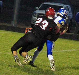 Bennie Elven sacks Genesee’s quarterback. One of 16 negative plays by the Bulldogs.