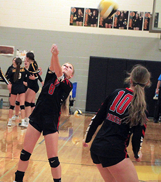 Sierra Oliver bumps the ball over the net at the Timberline Tournament. Also shown is Kylie Schumacher.