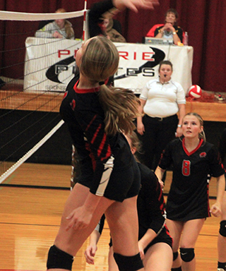 Lexi Schumacher goes up for one of her 24 kills against Kamiah last Tuesday. Also shown are Kylie Schumacher and Sierra Oliver.