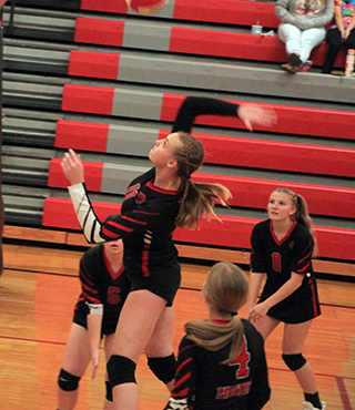 Alli Geis goes up for a spike at C.V. Also shown are Tamden Pecarovich, Lexi Schumacher and Sierra Oliver.