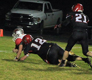 Matt Wemhoff sacks C.V.’s quarterback. It was one of several sacks he had in the game. Also shown is Levi McElroy.