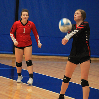 Sydney Shears passes the ball against Logos at District as Kaylie Lockett looks on.