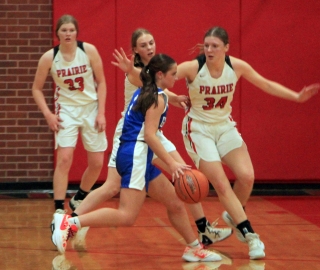 Prairie plays defense against Genesee. From left are Sage Elven, Alli Geis and Kylie Schumacher.