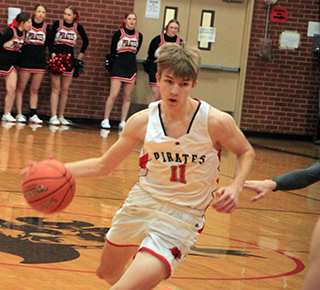 Briggs Rambo drives toward the hoop against Potlatch.