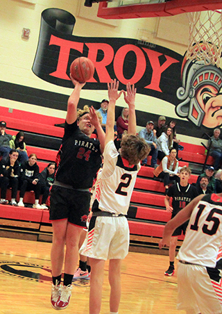 Noah Behler puts up a shot at Troy. Also shown is Phil Schwartz.