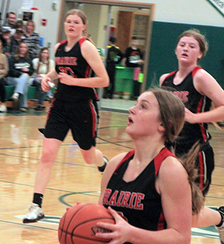 Lexi Schumacher pulls up for a shot at Potlatch. Also shown are Sage Elven and Hailey Hanson.