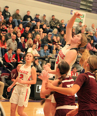 Hailey Hanson puts up a shot against Kamiah at District as Lexi Schumacher watches.