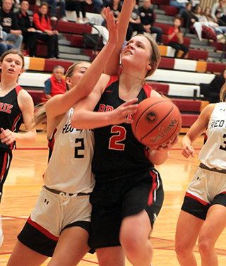 Lexi Schumacher gets fouled on a lay-up attempt against Murtaugh. At left is Sydney Shears.