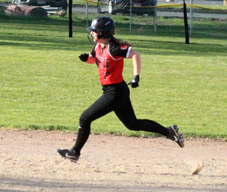 Ember Martin heads for third with a triple and wound up scoring when the throw from the outfield got away.