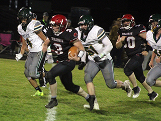 Dylan Uhlenkott breaks free for his fourth touchdown against Potlatch that clinched the win for the Pirates. Also shown is Jake Quintal.