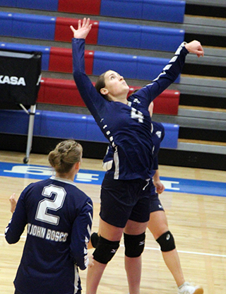 Sarah Waters goes for a spike against Coeur du Christ. Also shown is Julia Wassmuth.