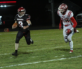 Dylan Uhlenkott looks to get past a Grace defender. Photo by Eric Coffelt.