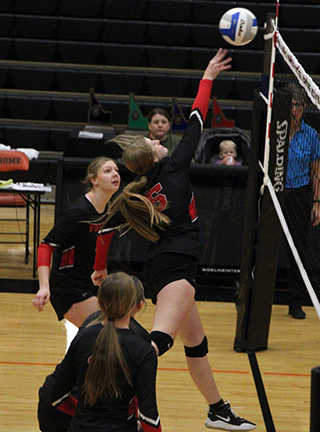 Hailey Hanson puts the ball over the net at State. Also shown are Kylie Schumacher, Tamden Pecarovich and Sydney Shears.