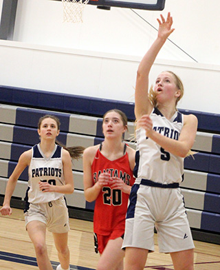 Catherine Seubert scores 2 of her game high 20 points against Clarkston. Also shown is Catherine Beckman.