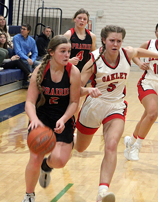 Lexi Schumacher with the ball against Oakley. Also shown is Sydney Shears.