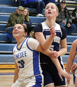 Catherine Seubert battles Genesee's Chloe Grieser for rebounding position.