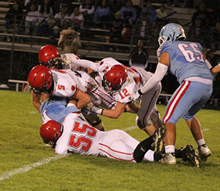 Half of Prairie’s defense tackles Lapwai’s quarterback. Shown are Corbyn Tacke, 55, Trajan Elven, 5, Sam Rehder, 12 and Lane Mader in the back.