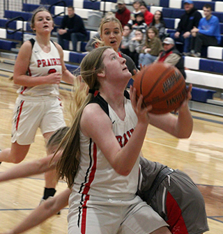 Hailey Hanson goes for a lay-up against Grace. Also shown is Lexi Schumacher.