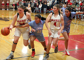 A Lapwai player tries to strip the ball from Kylie Schumacher. At right is Sydney Shears and Erica Schlader is in the background.