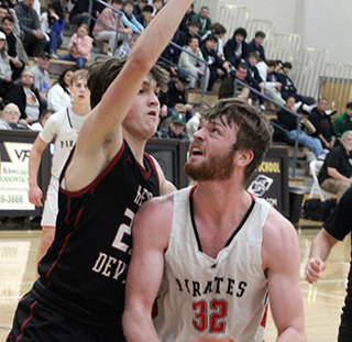 Nate Forsmann looks to shoot a lay-up against Murtaugh. Also shown is Phil Schwartz.